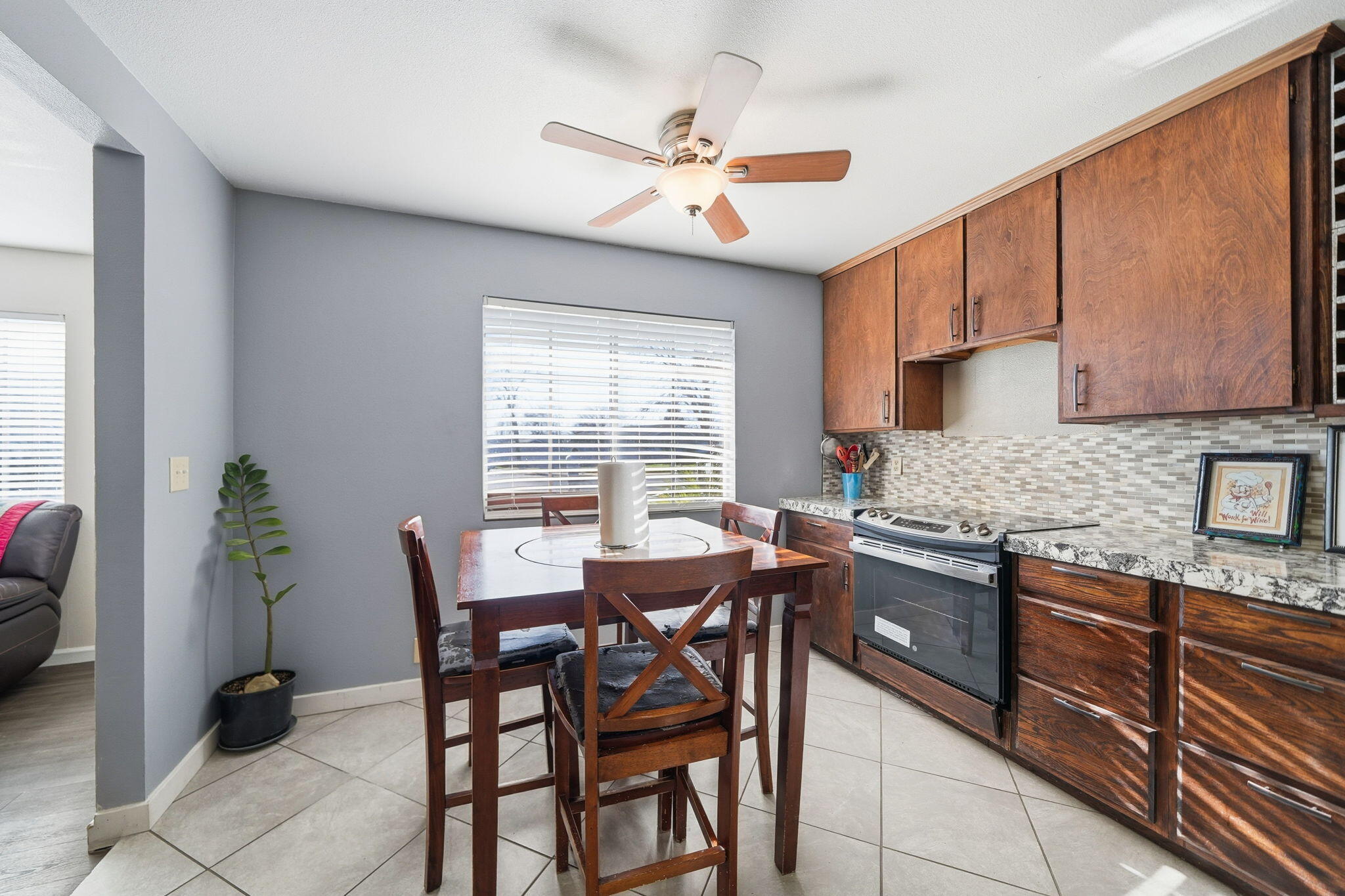 3661 Rabbit Lane Cottonwood, CA 96022 - Photo 11 of 38 a kitchen with granite countertop a table chairs stove and cabinets