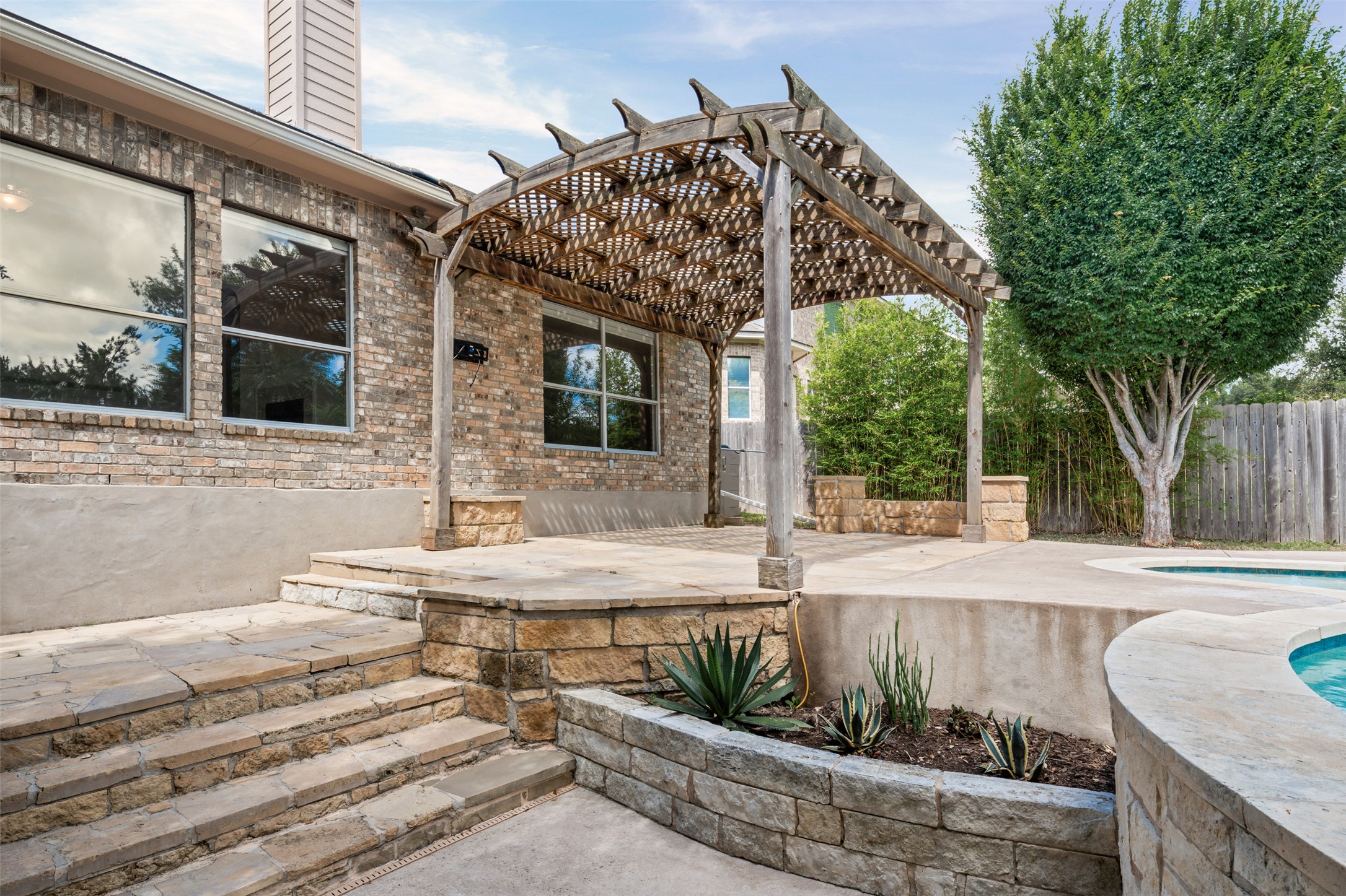 8820 Colberg Drive Austin, TX 78749 - Photo 31 of 35 An inviting backyard oasis offers a brick exterior, pergola-covered patio, and refreshing swimming pool.