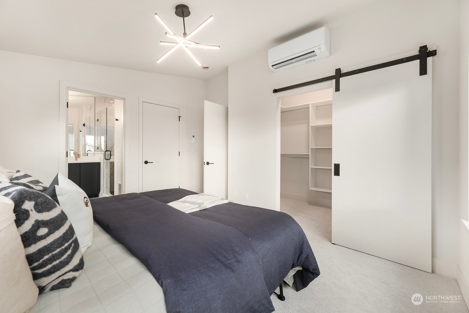 337 Northeast 90th Street, Unit 3 Seattle, WA 98115 - Photo 11 of 20 a bedroom with a bed and a chandelier