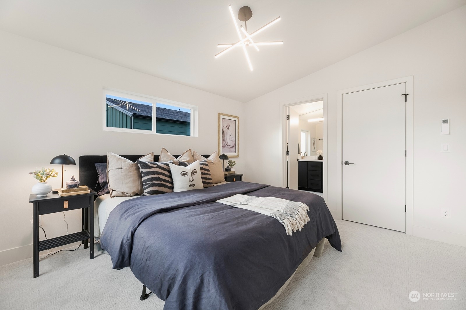 337 Northeast 90th Street, Unit 3 Seattle, WA 98115 - Photo 12 of 20 a bedroom with bed and a chandelier