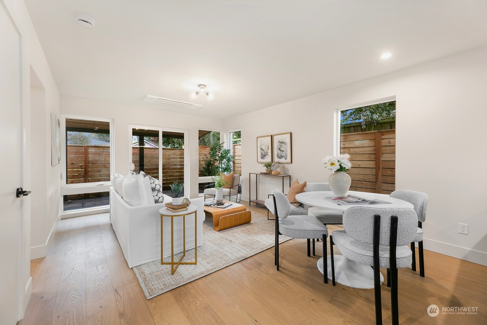 337 Northeast 90th Street, Unit 3 Seattle, WA 98115 - Photo 6 of 20 a living room with furniture a large window and wooden floor