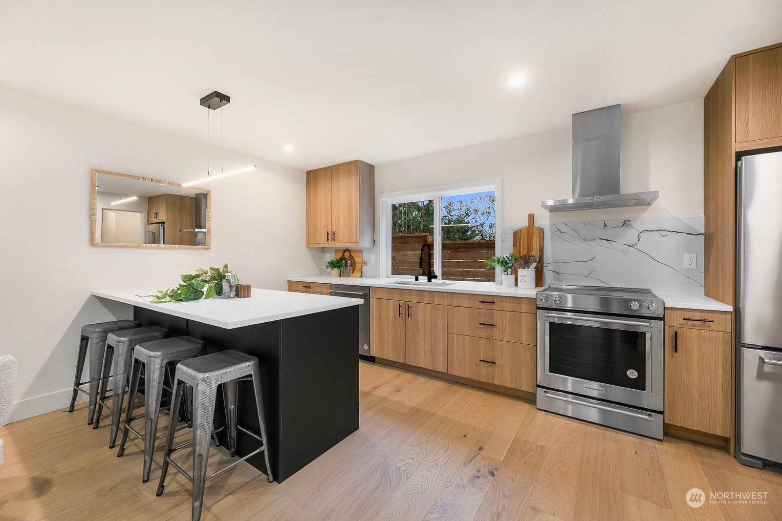 337 Northeast 90th Street, Unit 3 Seattle, WA 98115 - Photo 7 of 20 a kitchen with a sink and chairs