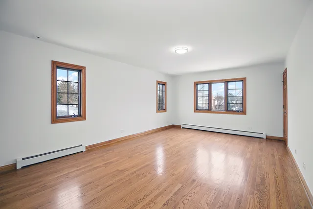 a view of a room with wooden floors and windows