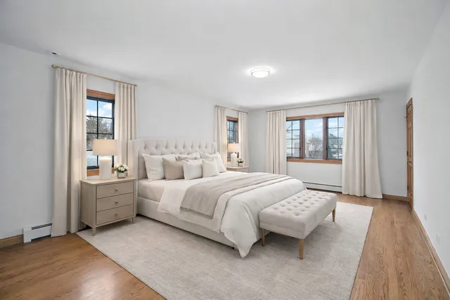 a spacious bedroom with a large bed and windows