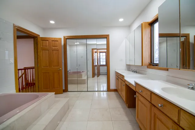 a spacious bathroom with a granite countertop sink and a large mirror