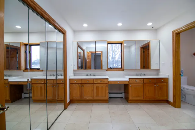 a large kitchen with a large counter top and sink