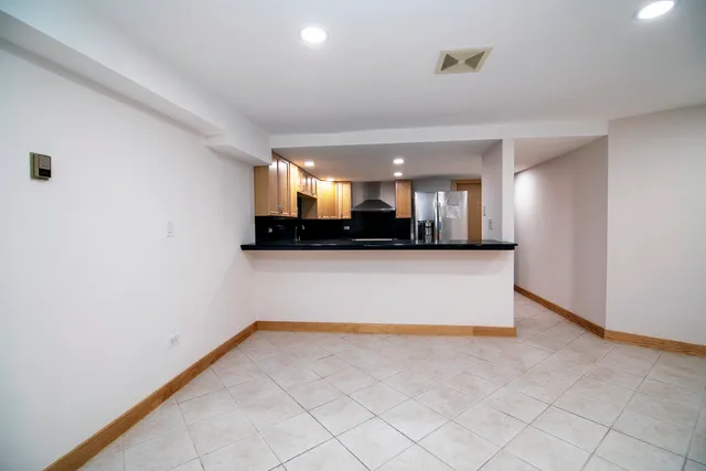 a view of a living room with kitchen