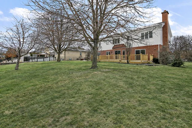 a brick house with trees in front of it