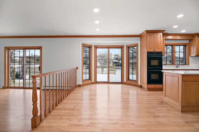 a view of a big room with wooden floor windows and a kitchen