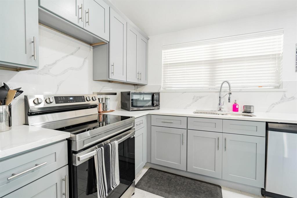 9884 Cherokee Trail Quinlan, TX 75474 - Photo 12 of 36 a kitchen with white cabinets and white appliances