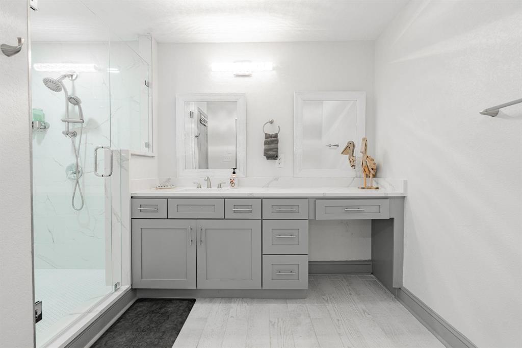 9884 Cherokee Trail Quinlan, TX 75474 - Photo 16 of 36 a bathroom with a double vanity sink mirror and shower