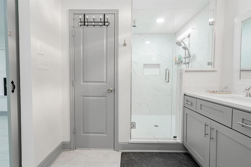 9884 Cherokee Trail Quinlan, TX 75474 - Photo 17 of 36 a bathroom with a shower sink and mirror