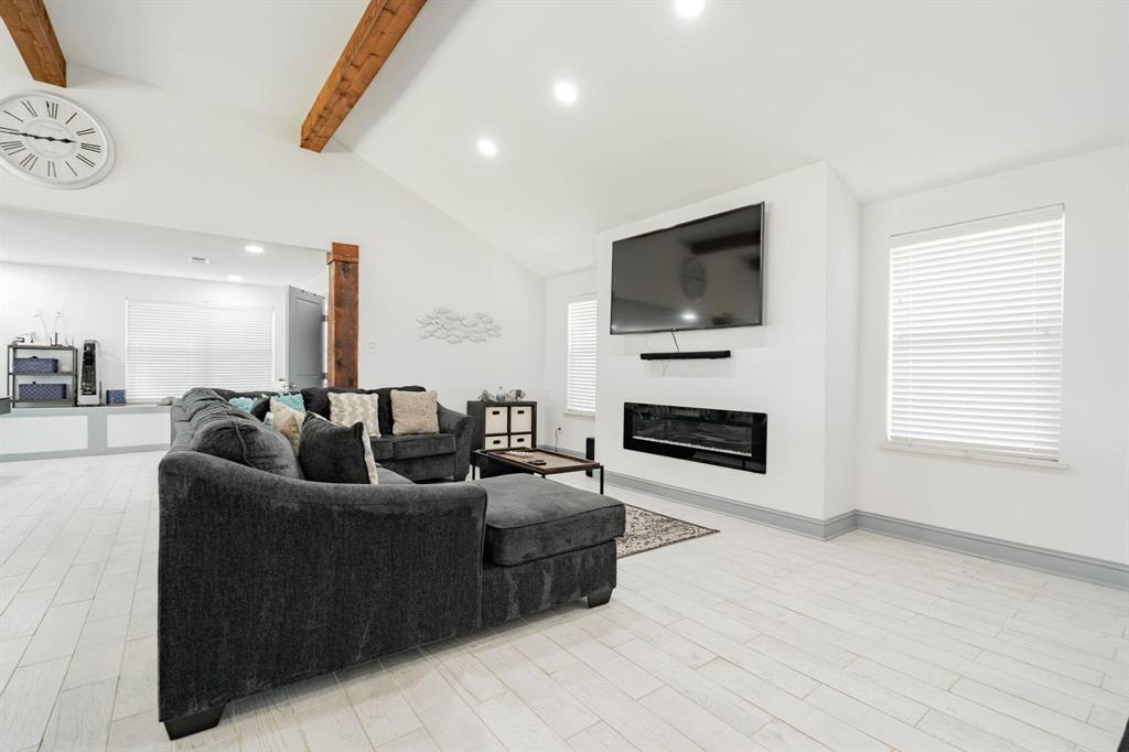 9884 Cherokee Trail Quinlan, TX 75474 - Photo 21 of 36 a living room with furniture a flat screen tv and a fireplace