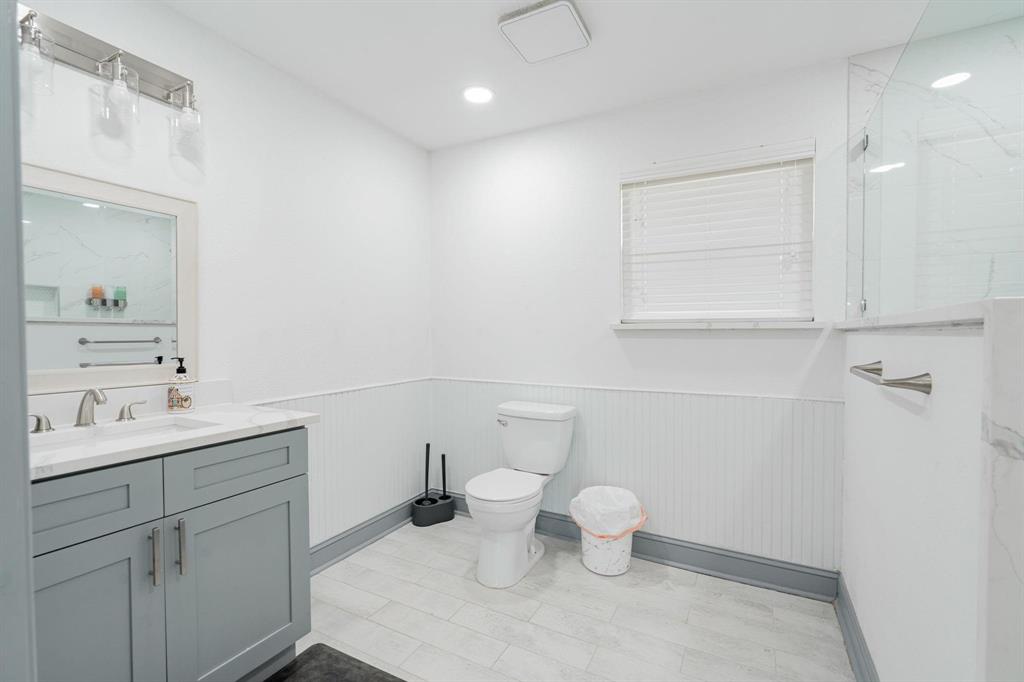 9884 Cherokee Trail Quinlan, TX 75474 - Photo 25 of 36 a bathroom with a toilet sink and mirror