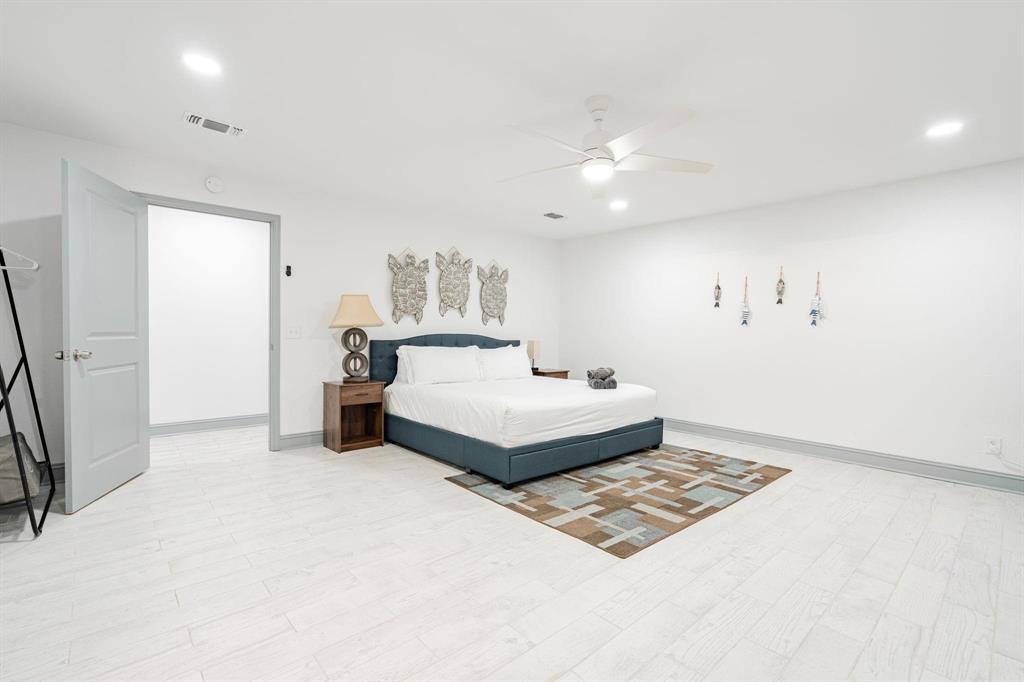9884 Cherokee Trail Quinlan, TX 75474 - Photo 28 of 36 a bedroom with a bed and a chandelier