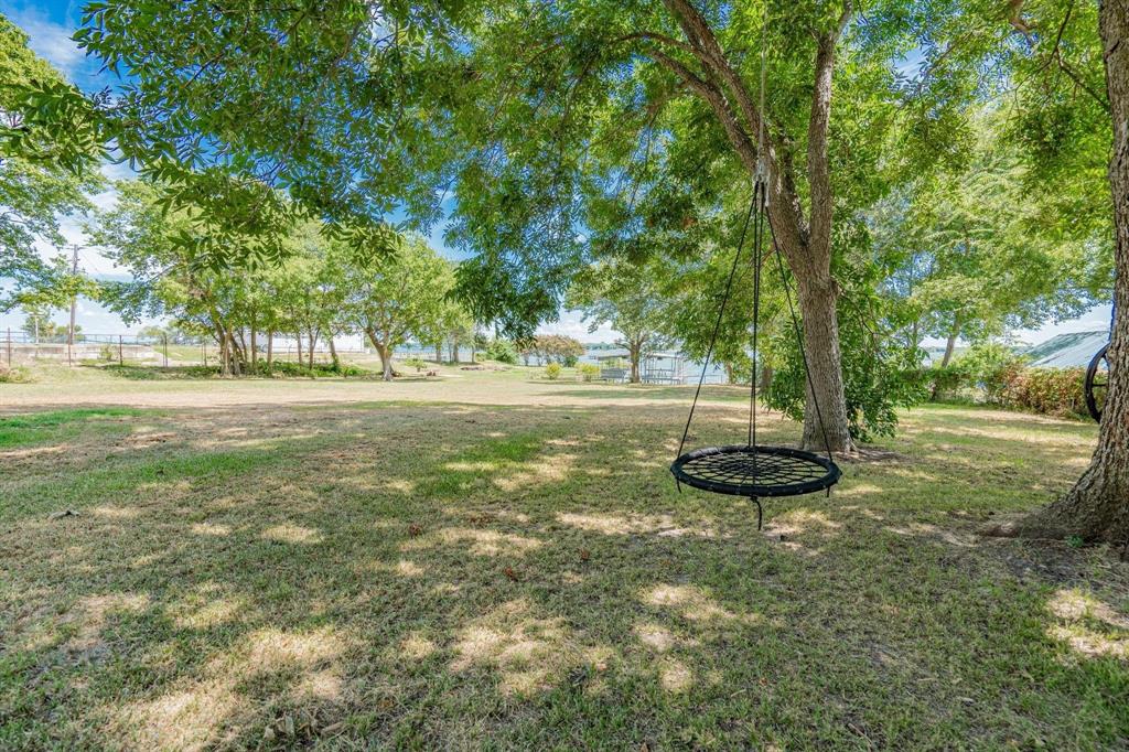 9884 Cherokee Trail Quinlan, TX 75474 - Photo 36 of 36 a view of a yard with a tree