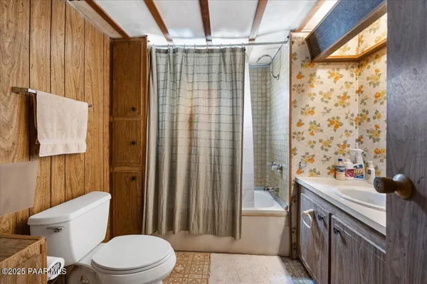 a bathroom with a sink a toilet a mirror and shower