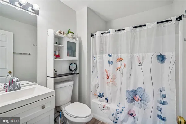 a bathroom with a sink toilet a shower curtain and a bath tub