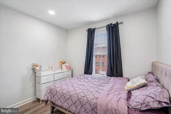 a bedroom with a bed and a desk