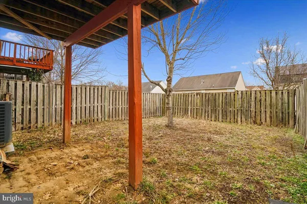 a view of a backyard with fence