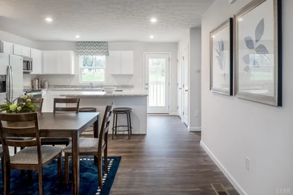 a view of a dining room with furniture and wooden floor