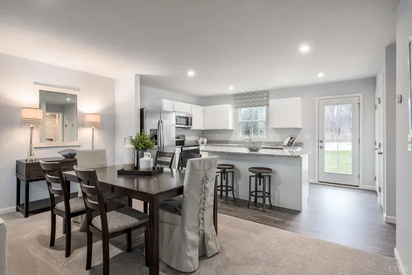 a kitchen with a table and chairs in it