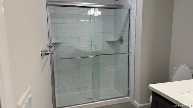 135 Cooper Road, Unit 3 Fishkill, NY 12524 - Photo 19 of 22 Primary Bathroom with toilet, vanity, tile patterned floors, and an enclosed shower
