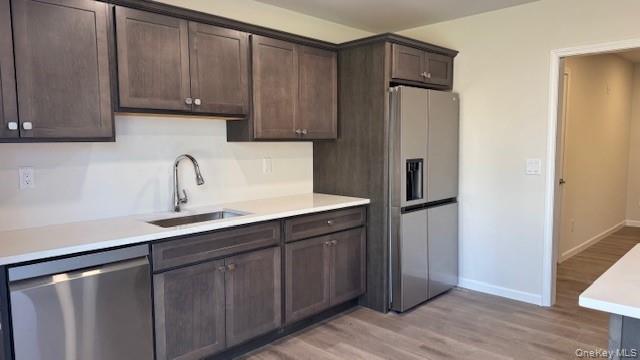 135 Cooper Road, Unit 3 Fishkill, NY 12524 - Photo 6 of 22 Kitchen with appliances with stainless steel finishes, dark brown cabinets, and sink