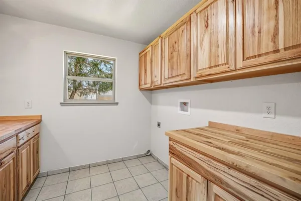 a bedroom with a sink and cabinets
