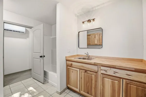 a bathroom with a sink a toilet and mirror