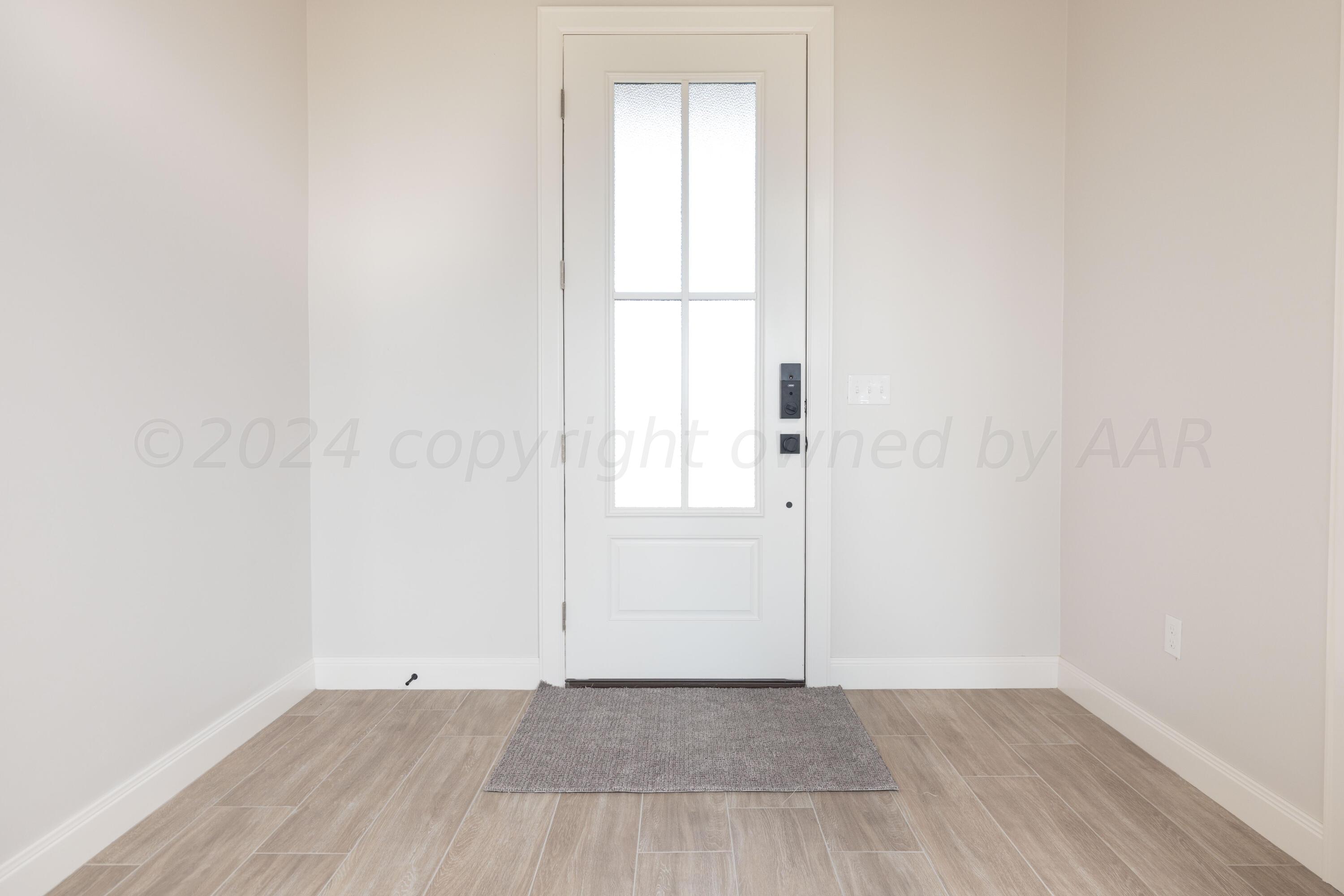 10151 Cactus Flower Road Amarillo, TX 79119 - Photo 12 of 29 an empty room with wooden floor and windows