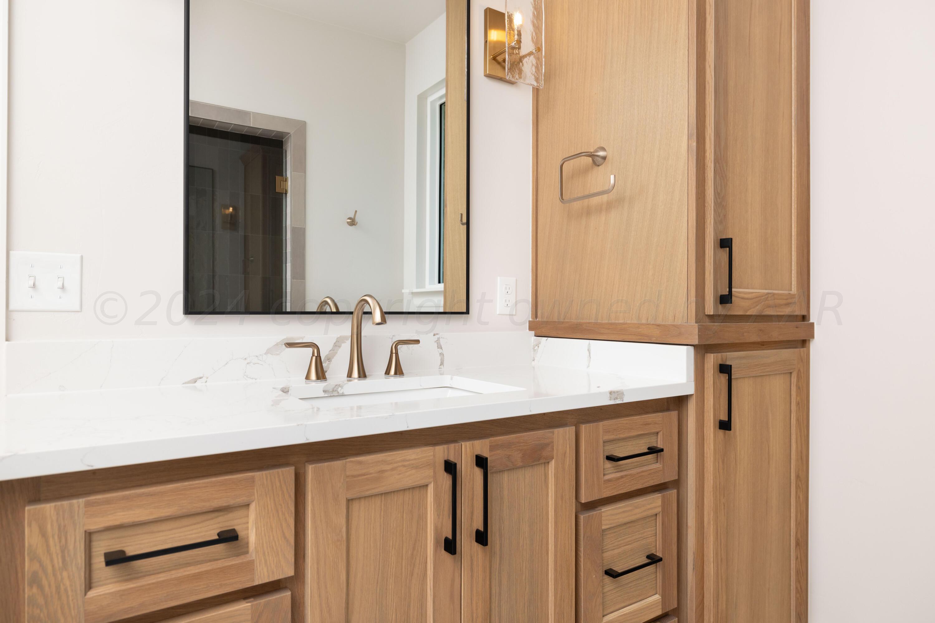 10151 Cactus Flower Road Amarillo, TX 79119 - Photo 17 of 29 a bathroom with a sink and a mirror