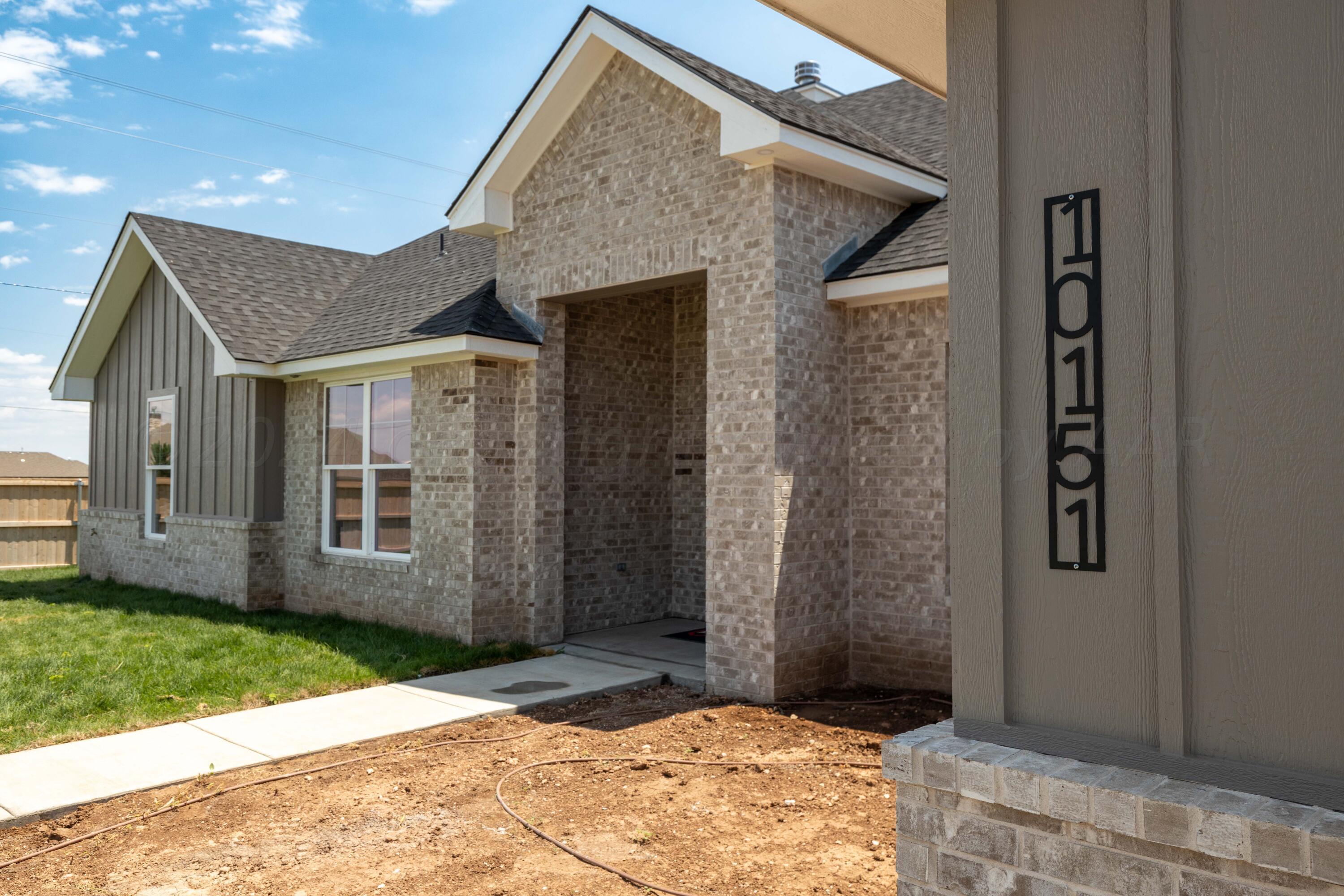 10151 Cactus Flower Road Amarillo, TX 79119 - Photo 2 of 29 a view of a brick house with a large windows