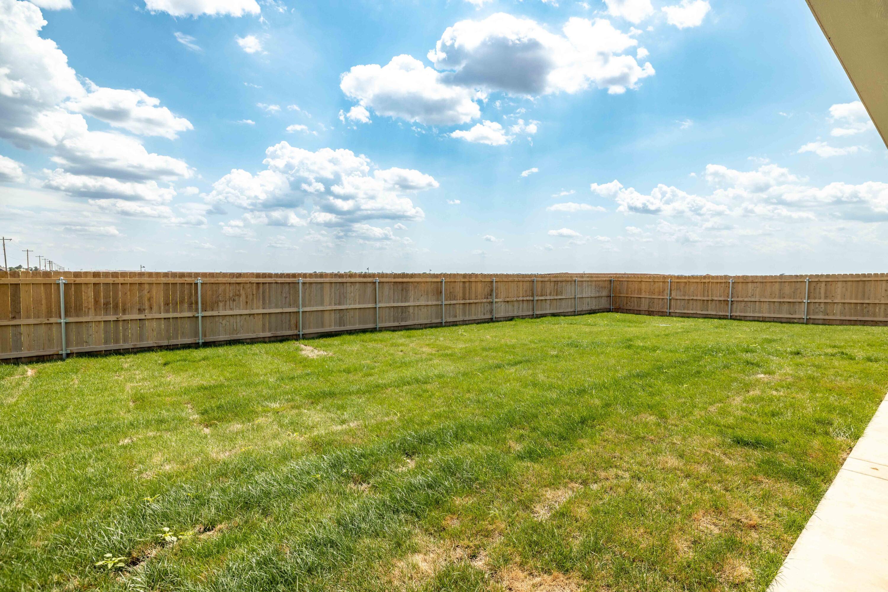 10151 Cactus Flower Road Amarillo, TX 79119 - Photo 28 of 29 a view of yard with swimming pool and wooden fence