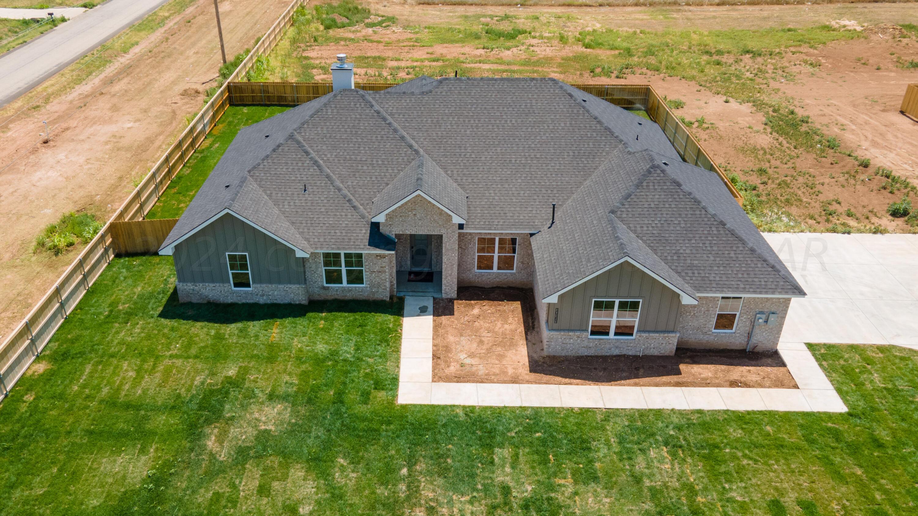 10151 Cactus Flower Road Amarillo, TX 79119 - Photo 3 of 29 a front view of a house with a yard and garage