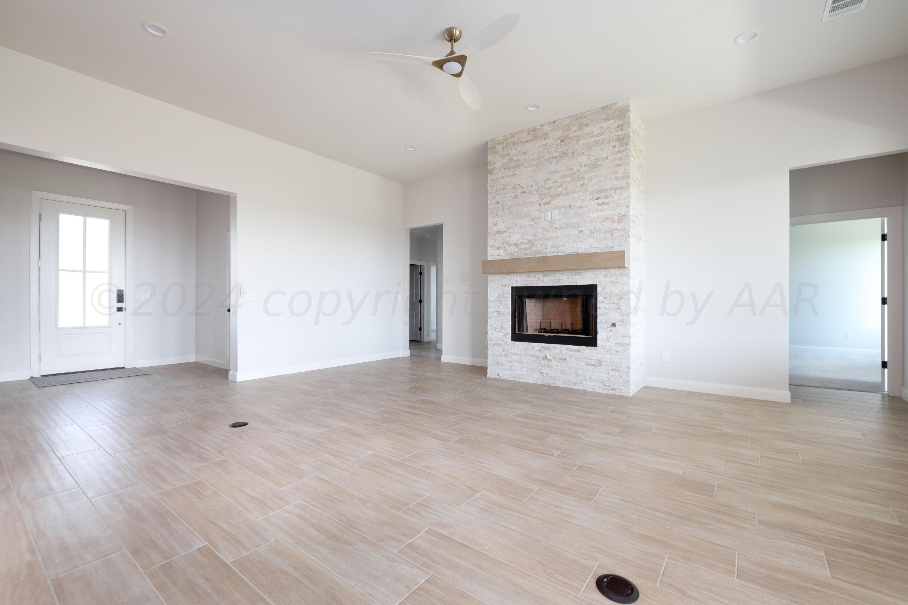 10151 Cactus Flower Road Amarillo, TX 79119 - Photo 9 of 29 a view of empty room with wooden floor and fireplace