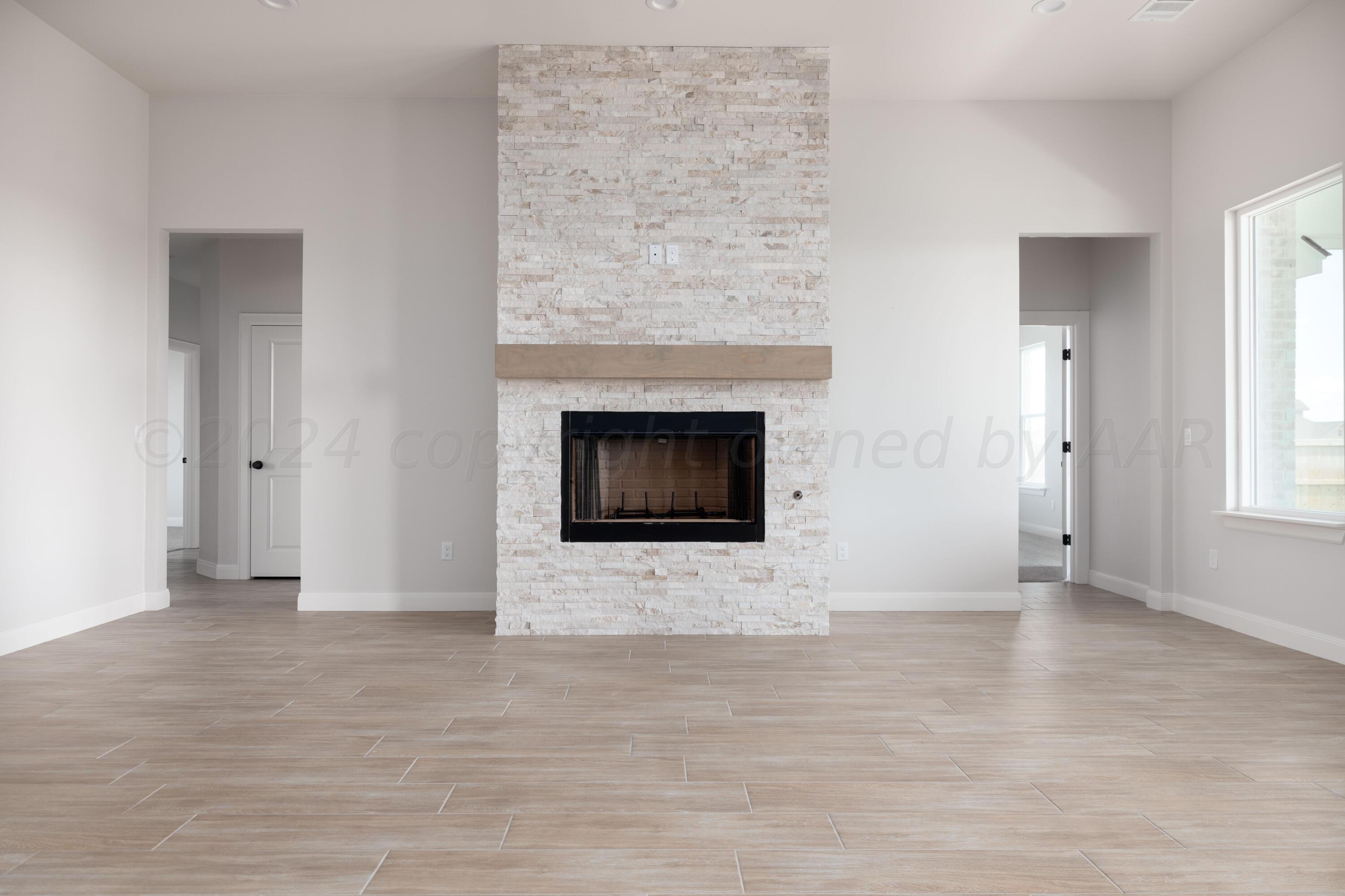 10151 Cactus Flower Road Amarillo, TX 79119 - Photo 10 of 29 a view of an empty room with wooden floor and fireplace