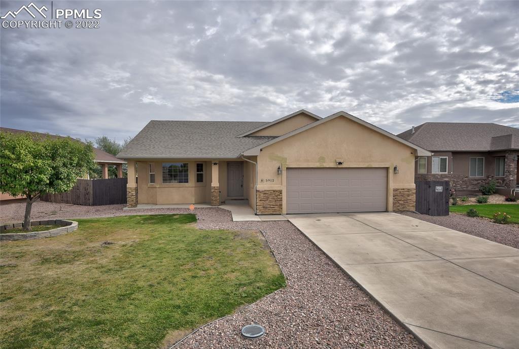 5912 Polly Court Pueblo, CO 81008 - Photo 1 of 40 a front view of a house with garden