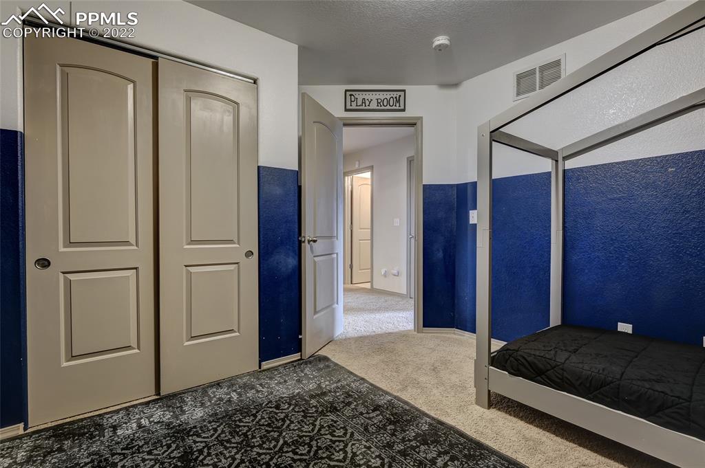 5912 Polly Court Pueblo, CO 81008 - Photo 18 of 40 a bedroom with a bed and a mirror