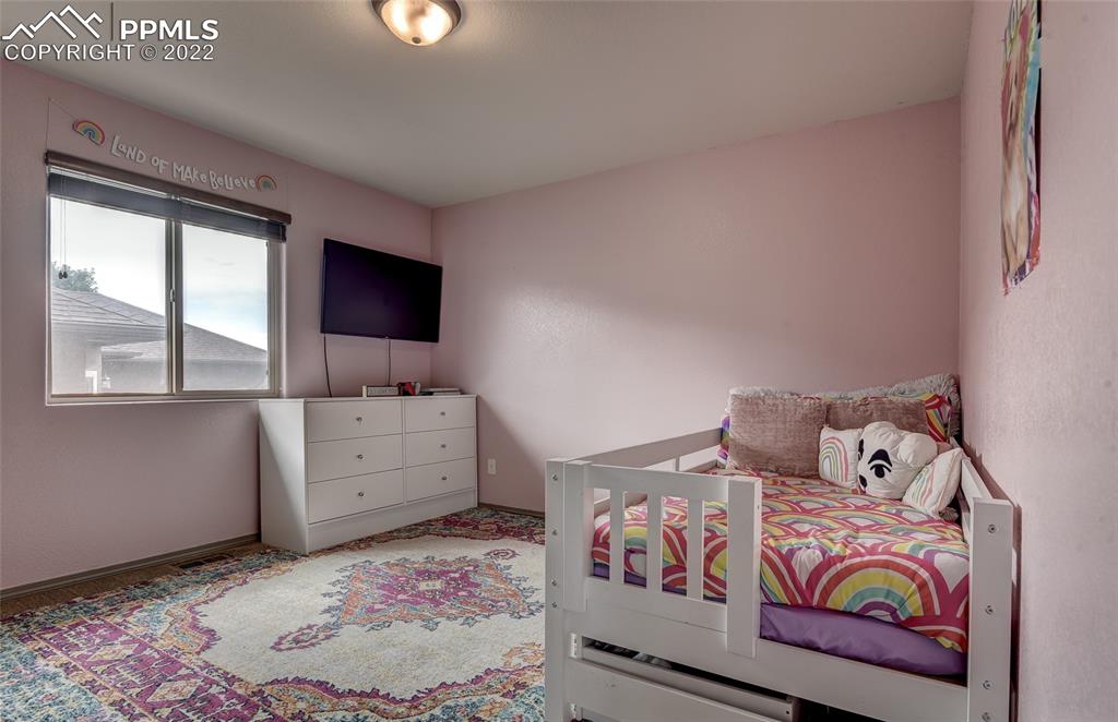 5912 Polly Court Pueblo, CO 81008 - Photo 19 of 40 a bedroom with a bed and a window