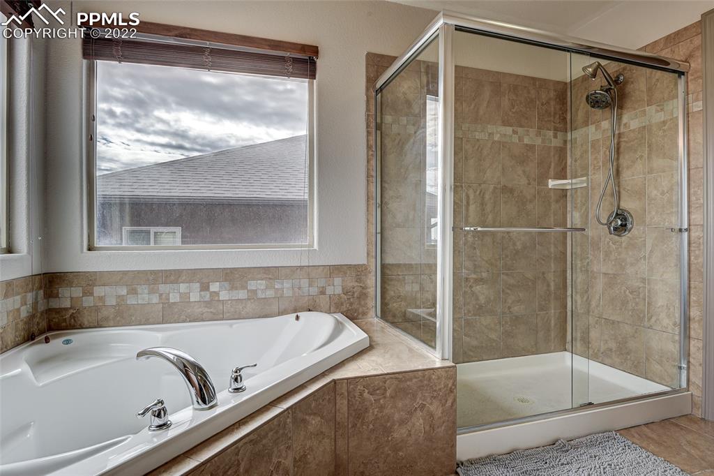 5912 Polly Court Pueblo, CO 81008 - Photo 26 of 40 a bathroom with a tub and a shower