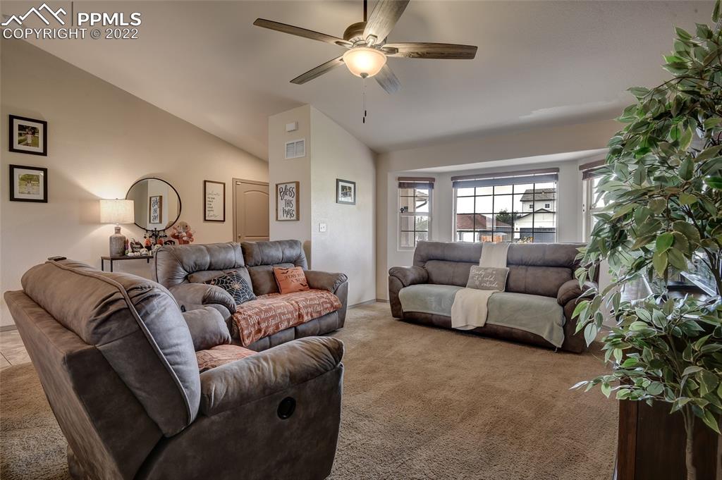 5912 Polly Court Pueblo, CO 81008 - Photo 8 of 40 a living room with furniture and a chandelier
