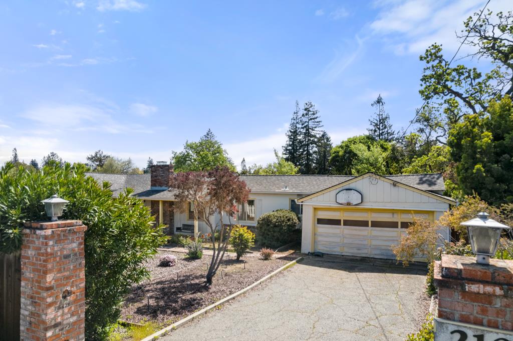 2101 Sharon Road Menlo Park, CA 94025 - Photo 2 of 31 a front view of a house with a yard and tree s