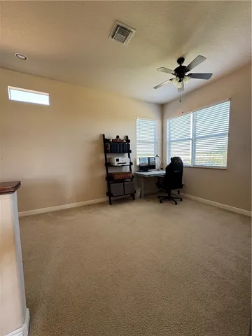 a view of a livingroom with furniture and a ceiling fan