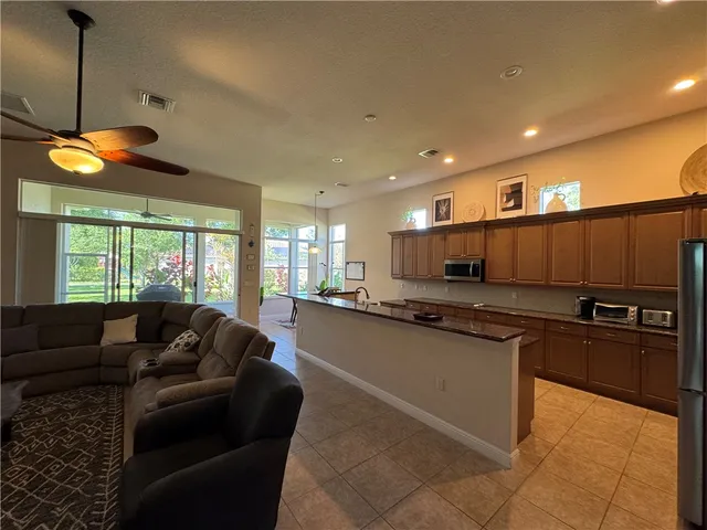 a kitchen with stainless steel appliances granite countertop a sink a stove and a refrigerator