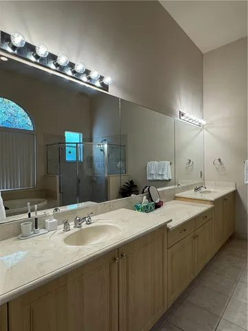 a bathroom with double sink and a mirror