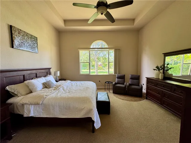 a bedroom with a bed a couch and a window