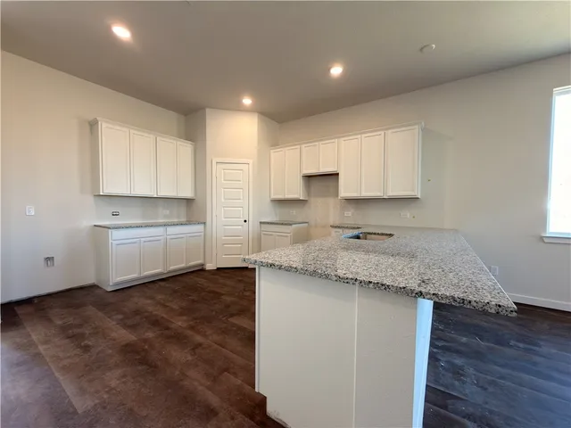 a view of kitchen and wooden floor