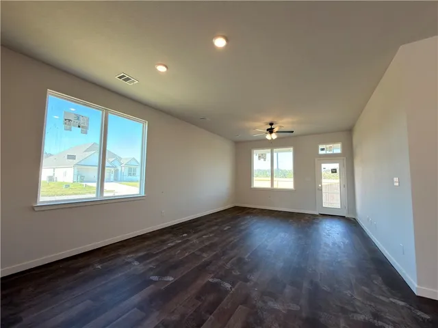 a kitchen with granite countertop a sink stove and cabinets