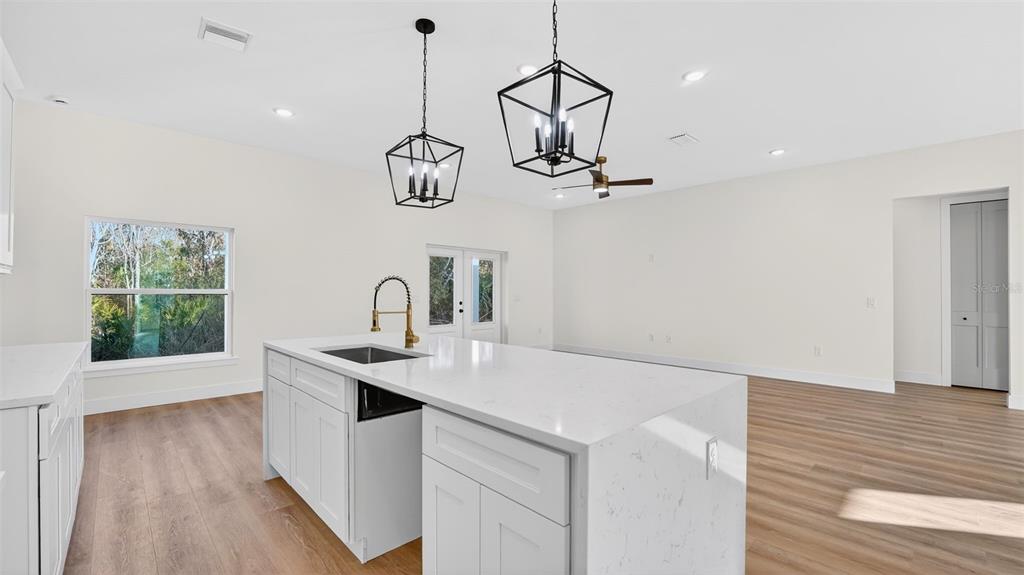 257 Lago Vista Street DeBary, FL 32713 - Photo 15 of 35 a kitchen with a sink a counter space wooden floor and appliances